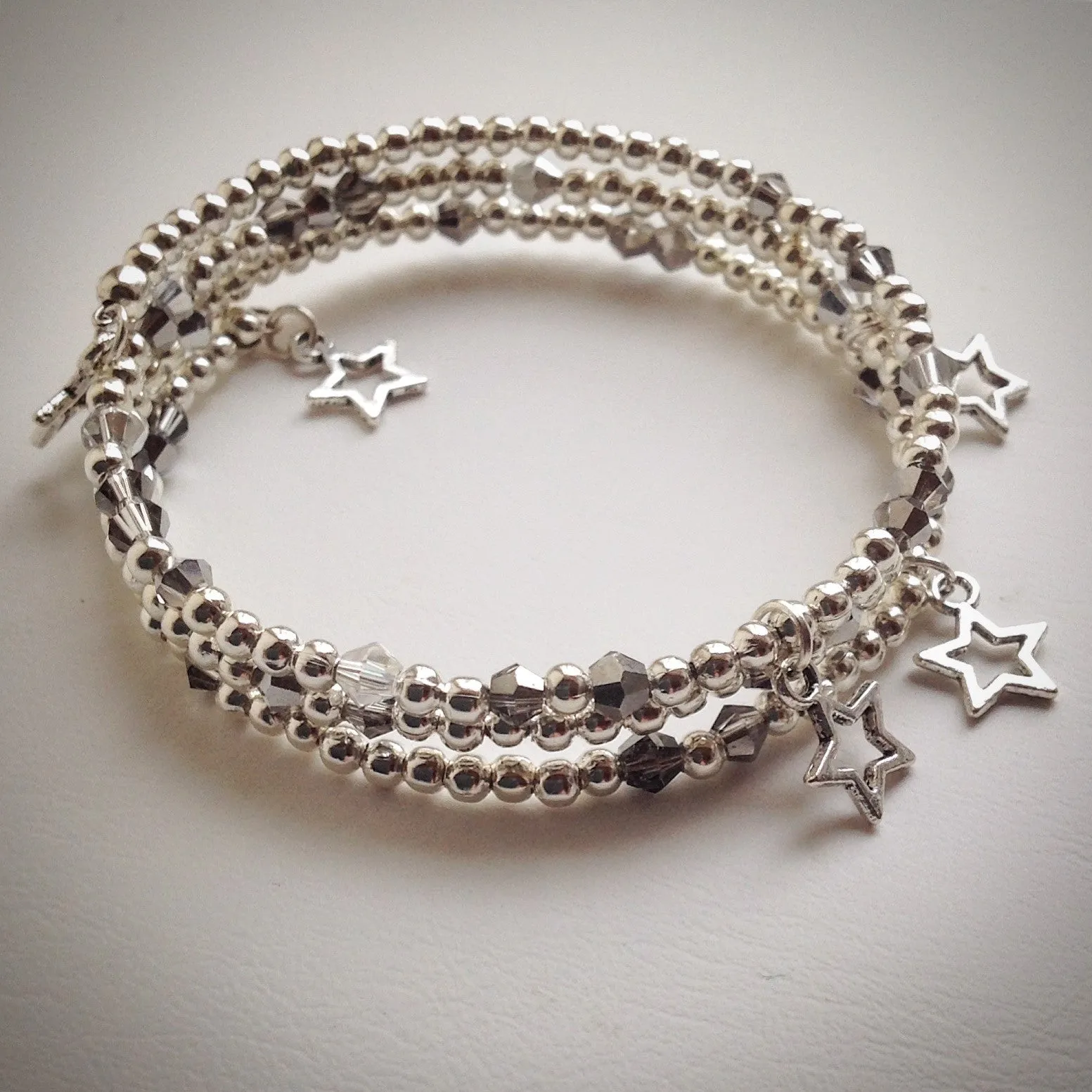 Beaded memory wire bracelet - triple wrap silver with Swarovski and stars
